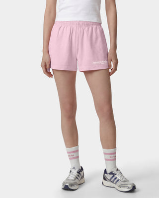 The Fitness 94 Disco Short in Laffy/White features light pink cotton fleece, an elastic waistband, and a Sporty & Rich logo on the bottom right leg. Made in the USA, it is displayed on a gray background.