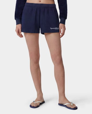 HWCNY Disco Short in Dark Navy/White is made from athletic cotton fleece, features an elastic waistband, and has the Sporty & Rich logo printed in white on the lower left leg. Made in the USA.