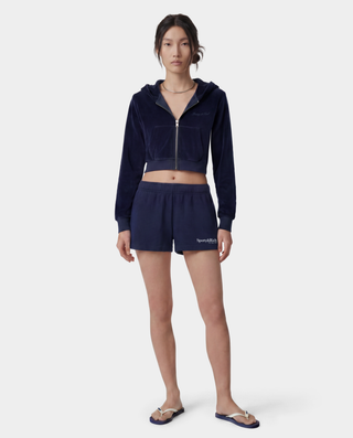 HWCNY Disco Short in Dark Navy/White is made from athletic cotton fleece, features an elastic waistband, and has the Sporty & Rich logo printed in white on the lower left leg. Made in the USA.