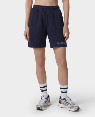 The HWCNY Gym Short in Dark Navy/White, made in the USA and crafted from 100% cotton for superior comfort and breathability, features a white Sporty & Rich print on the left leg and is displayed laid flat on a white background.