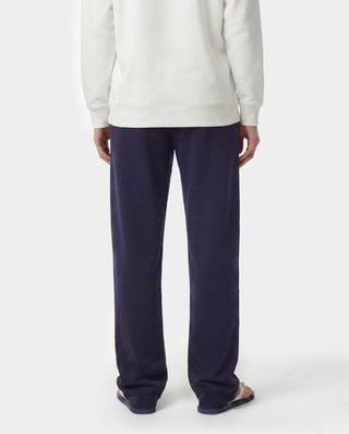 Wellness Ivy Wide Sweatpant in Dark Navy/White, featuring "WELLNESS" text on the left pocket, made from 100% cotton with an elastic waistband, displayed flat on a white background.