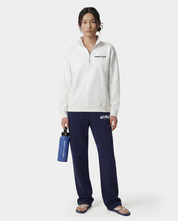 Wellness Ivy Wide Sweatpant in Dark Navy/White, featuring "WELLNESS" text on the left pocket, made from 100% cotton with an elastic waistband, displayed flat on a white background.
