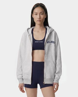 Presenting the Wellness Ivy Zip Hoodie in Heather Gray/Light Navy: an oversized-fit, 100% cotton zip-up hoodie featuring "WELLNESS" in light navy text on the left chest, complete with front pockets and a comfortable hood.