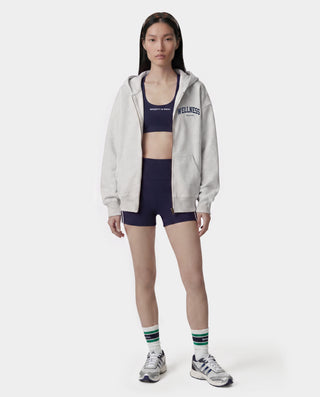 Presenting the Wellness Ivy Zip Hoodie in Heather Gray/Light Navy: an oversized-fit, 100% cotton zip-up hoodie featuring "WELLNESS" in light navy text on the left chest, complete with front pockets and a comfortable hood.
