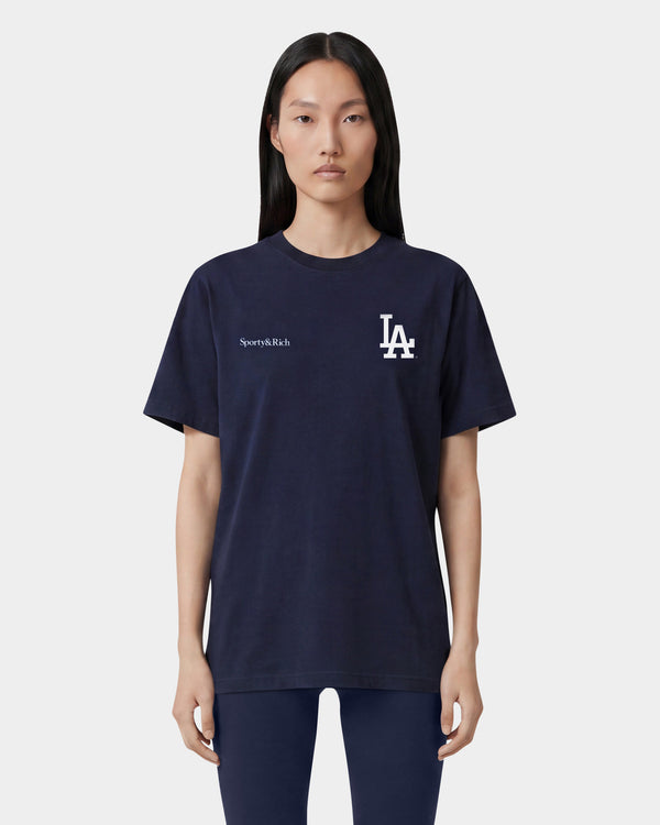 Dodgers Serif T-Shirt in Dark Navy/White, made from 100% cotton, features Sporty & Rich and LA logos in white on the upper front and offers an oversized fit.