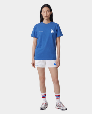 Dodgers Serif T-Shirt in Team Blue/White, featuring an LA logo and Sporty & Rich text on the front, crafted from 100% cotton for comfort, designed with an oversized fit, and shown against a plain background.