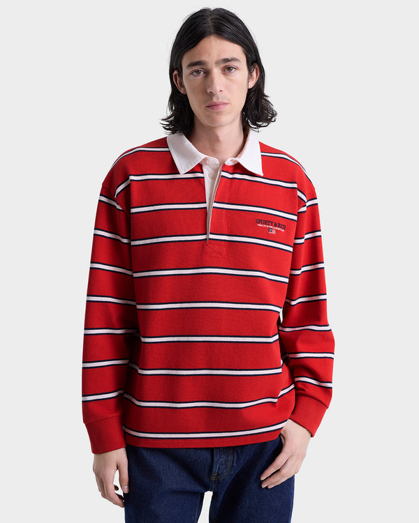 Person wearing a red and white striped rugby polo on a plain background