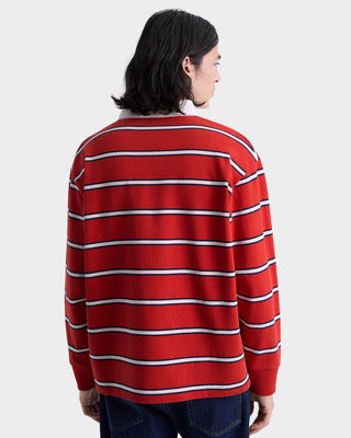 Person wearing a red and white striped sweater on a plain background