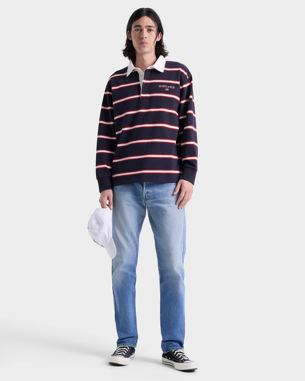 Person wearing a striped rugby shirt and jeans on a white background