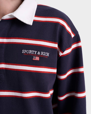Navy rugby shirt with red and white stripes featuring 'Sporty & Rich' logo.