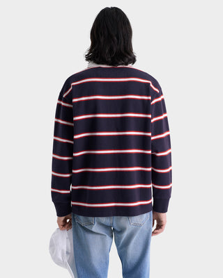 Person wearing a navy and red striped sweater on a white background