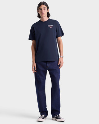 Person wearing a navy t-shirt and jeans on a white background
