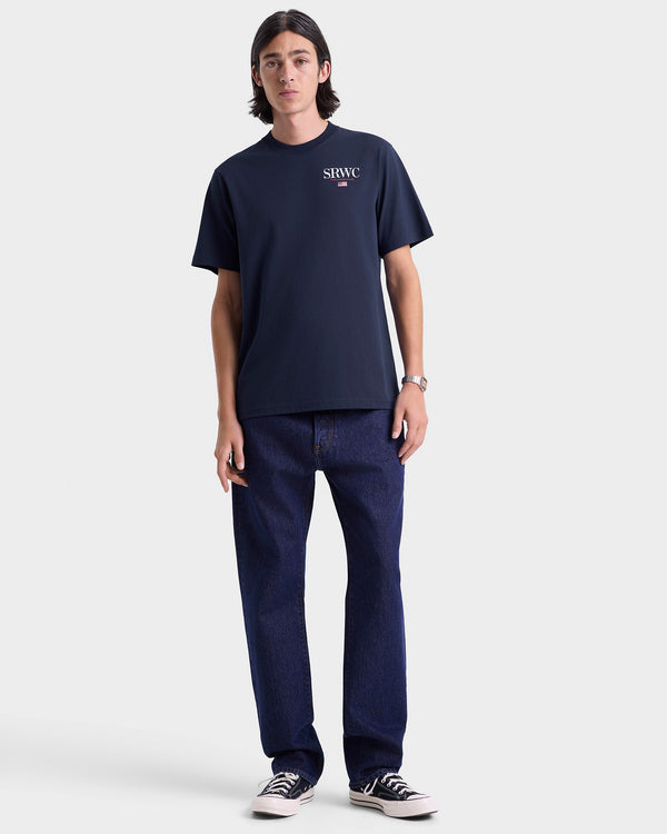 Person wearing a navy t-shirt and jeans on a white background