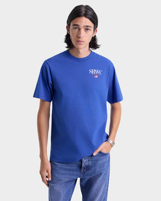 Person wearing a blue t-shirt with a logo on a white background