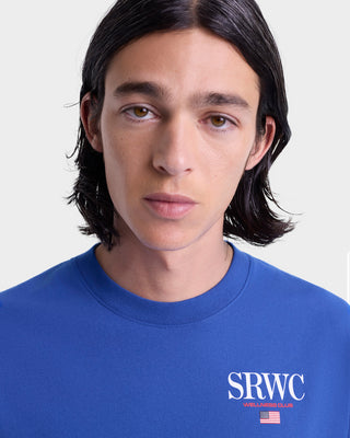 Person wearing a blue shirt with 'SRWC' logo on a white background
