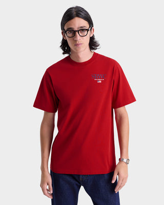 Person wearing a red t-shirt with a logo on a white background