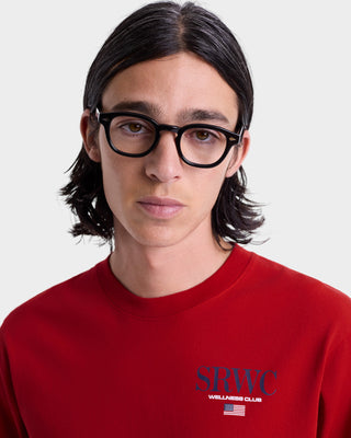 Person wearing a red sweatshirt with 'SRWC Wellness Club' text on a white background