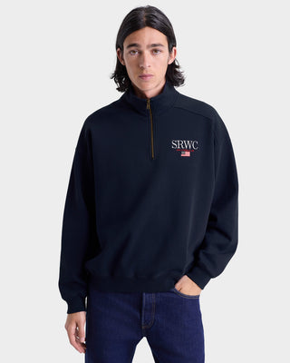 Person wearing a navy blue sweatshirt with 'SRWC' logo on a light gray background