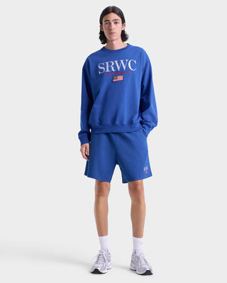 Person wearing a blue sweatshirt and shorts with 'SRWC' branding on a white background