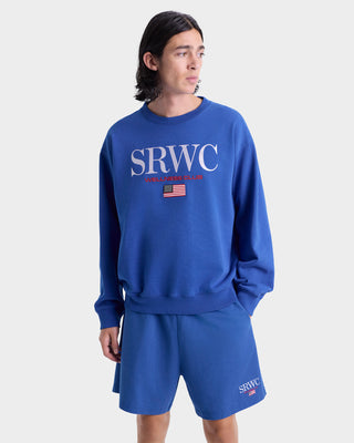 Person wearing a blue sweatshirt and shorts with 'SRWC' branding on a white background