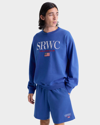 Person wearing a blue 'SRWC' sweatshirt and shorts on a white background