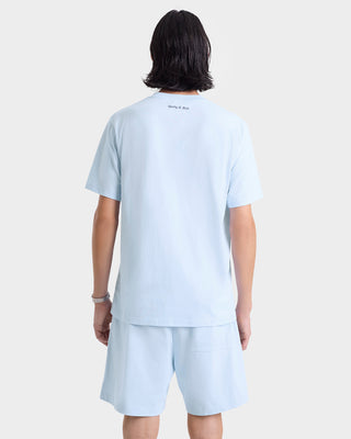 Person with medium-length dark hair shown from the back, wearing a light blue t-shirt and Eden Crest Gym Short - Ciel/Navy.