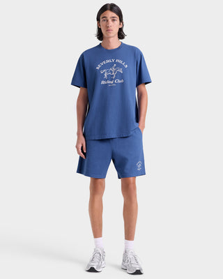 Person wearing a blue t-shirt and shorts with a logo on a white background