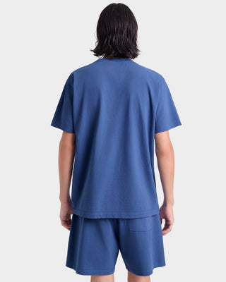 Person wearing a blue outfit with a plain background