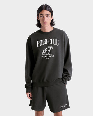 Person wearing a black 'Polo Club' sweatshirt and shorts on a white background