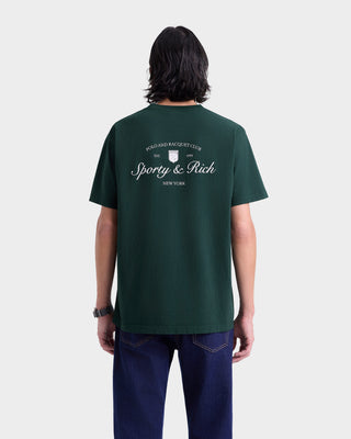 Person wearing a green t-shirt with 'Sporty & Rich' logo on the back, standing against a white background