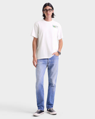 Person wearing a white t-shirt and blue jeans on a white background
