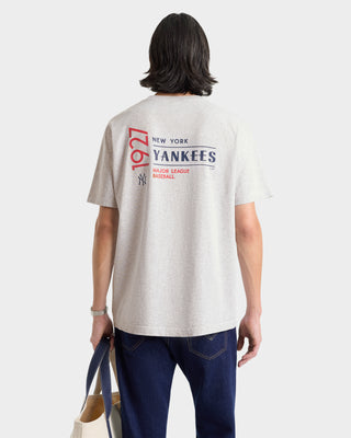 Person wearing a New York Yankees t-shirt with text on the back.