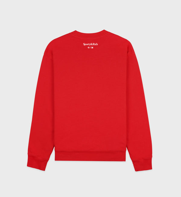 Red sweatshirt with a brand logo on the back against a light gray background