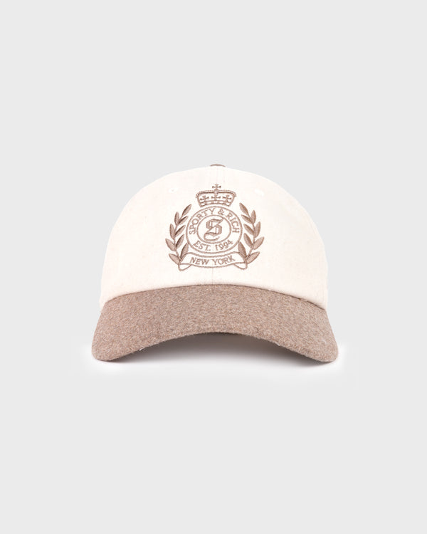 The NY Crest Wool Hat in Ecru/Toffee is made from 100% wool and features an embroidered crest with New York text on the front. This beige and brown baseball cap includes an adjustable closure for a comfortable fit.