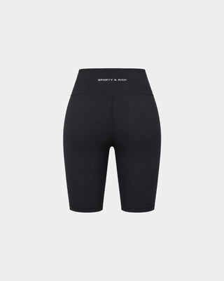 Brooke Bold Logo Biker Short - Black: High-waisted black biker shorts with a 6-inch inseam and supportive high-rise waistband, shown against a plain white background.