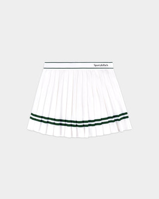 The Ally Serif Logo Pleated Skirt - White/Forest features crisp pleats and green forest stripes near the hem, with Sporty & Rich text on the elastic waistband and comfortable built-in shorts for ease of movement.