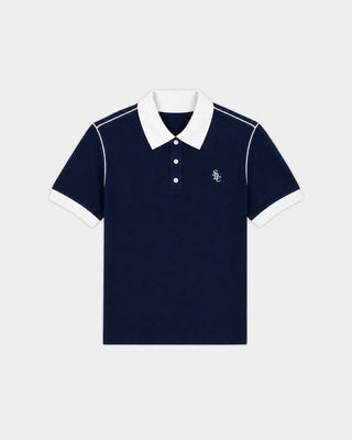 Flint SRC 70S Pique Polo in Dark Navy/White—crafted from cotton piqué with a white collar, white sleeve cuffs, and a subtle white chest logo, evoking timeless 70s tennis style.