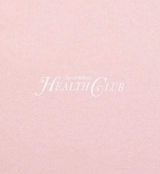 Pink background with white text reading Rizzoli Disco Short - Ballet/White in elegant serif font, inspired by our heavy jersey shorts with elastic waistband, proudly made in Los Angeles.