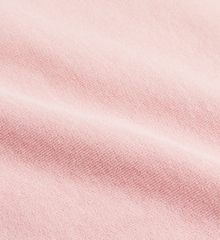 Close-up of soft light pink fabric with gentle folds, showcasing the quality of the Rizzoli Disco Short - Ballet/White, a heavy jersey short with elastic waistband made in Los Angeles.