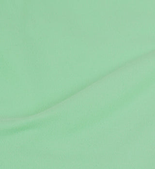 The Serif Logo Court Skirt in Washed Kelly/White features light green fabric and a subtle curved fold across the center, evoking the look of a classic tennis skirt.