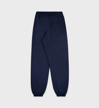 The Serif Logo Sweatpant in navy/white, made from premium USA cotton, includes an elastic waistband, ankle cuffs, and a back pocket. Presented on a plain gray background, these unisex sweatpants are crafted in the USA for ultimate comfort and durability.