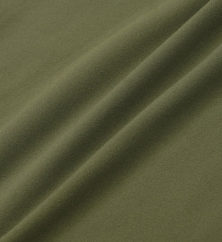 Close-up of Moss/White Serif Logo High Waisted Legging featuring luxurious olive green fabric with a soft texture and gentle vertical folds.