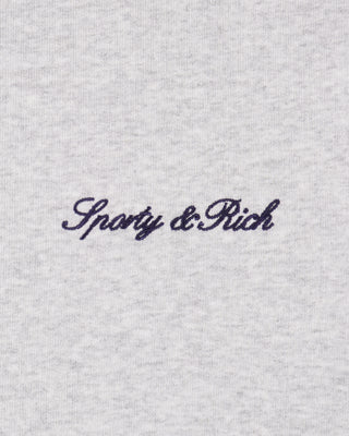 Text 'Sporty & Rich' embroidered on a textured gray fabric background