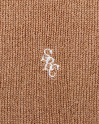 Close-up of a brown fabric with a white logo on a brown background