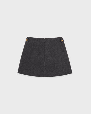 Dark gray skirt with gold buttons on a light gray background
