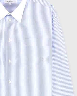 Blue and white striped shirt with a collar on a light gray background