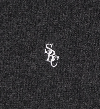 The SRC Turtleneck - Dark Gray features white embroidered SPC letters on textured dark gray 100% lambswool fabric. Made in Italy.
