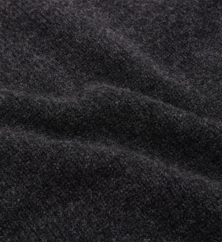 Close-up of the SRC Turtleneck in dark gray, crafted from 100% lambswool with a soft, fuzzy texture and visible fibers.
