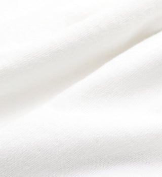 Close-up of the SR Health Club T-Shirt in White/Royal Blue, showcasing soft, white fabric with gentle folds and a smooth, slightly textured surface—crafted from USA-grown cotton.