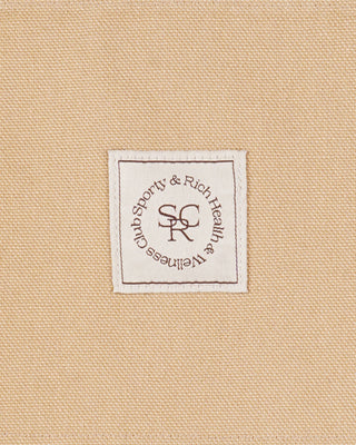 Label with 'Shorty & Rich' logo on a beige fabric background